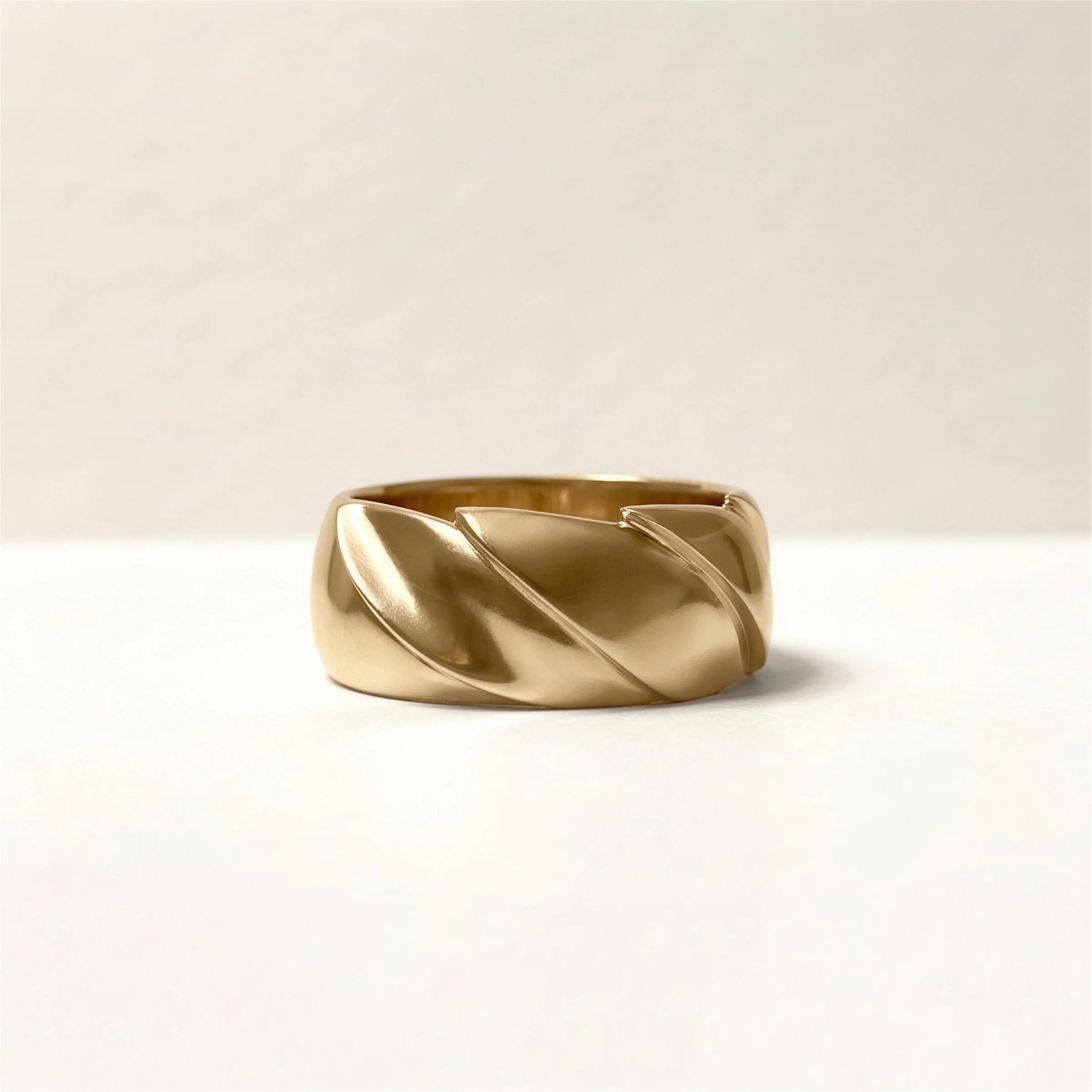 A gold band carved with a spiral, a custom commission