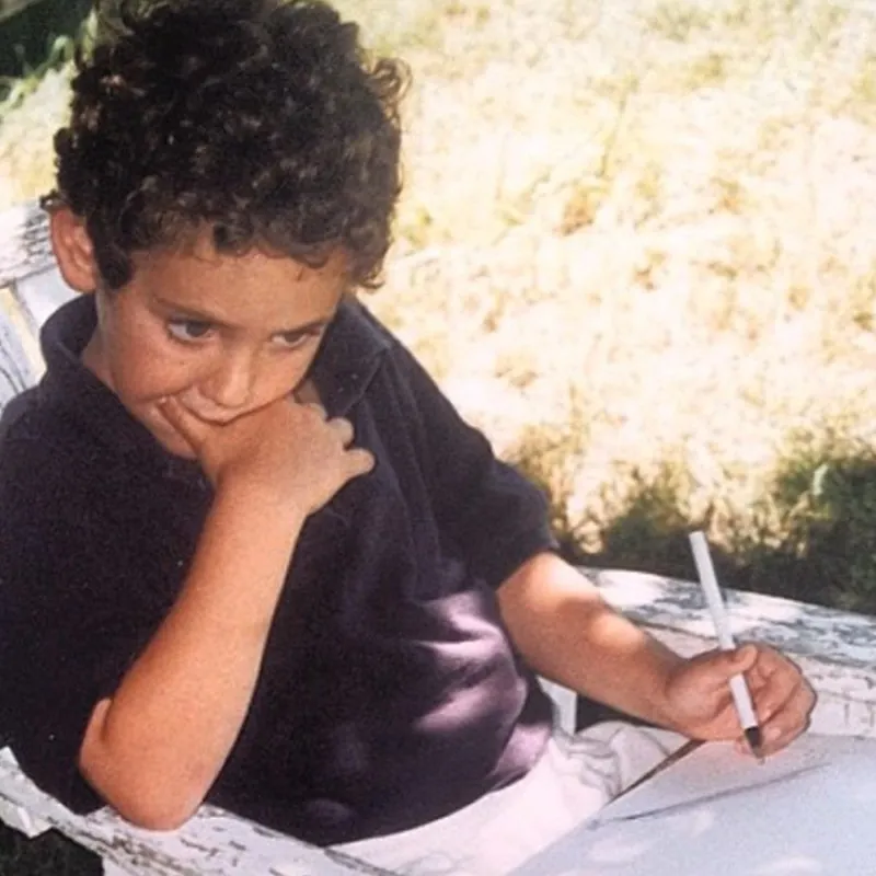 Alex as a child, drawing