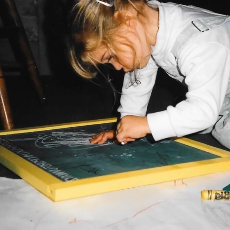Hannah as a child, drawing